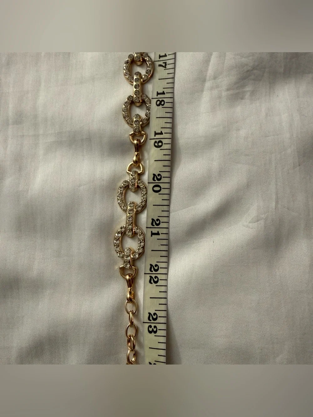 Gold tone oval links metal chain belt with rhinestone details
